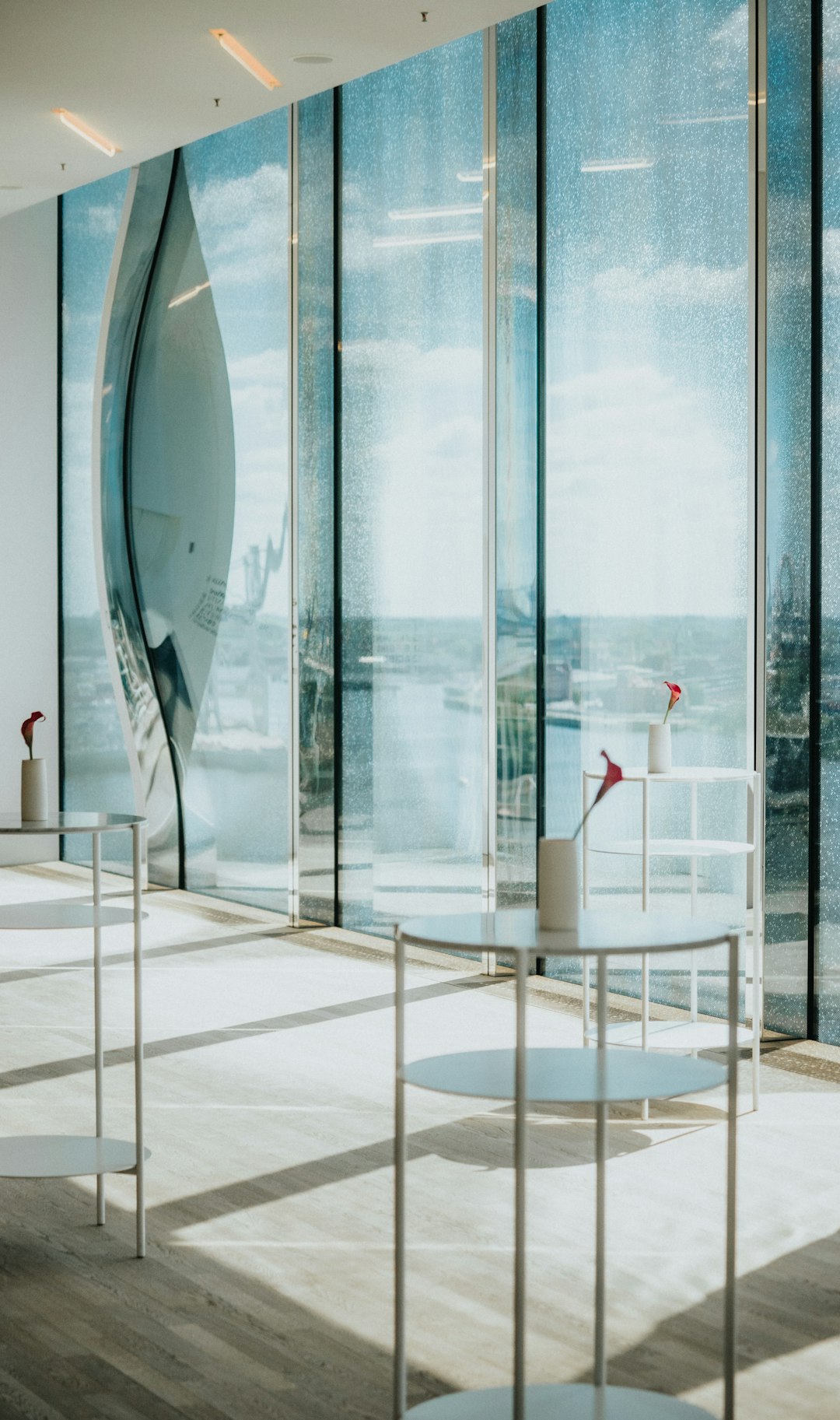 modern-interior-with-large-windows-and-small-tables-eb-t1fcwgsq